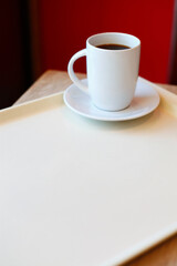 Coffee cup on a saucer on a tray