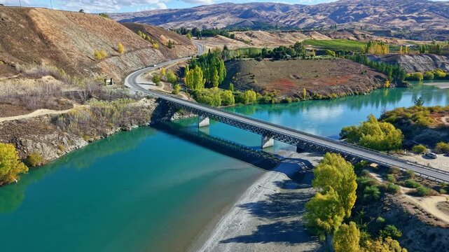 A serene bridge over Kawarau River in Bannockburn, New Zealand, scenic views