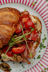 Croissant with filling on a beautiful plate isolated