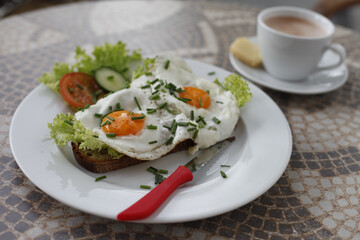 Delicious breakfast with fried eggs, toast, and coffee