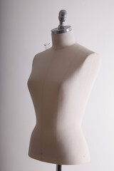 A dressmaker's mannequin stands in a studio, ready for the next design.