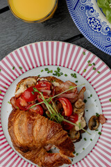 Croissant with filling on a beautiful plate isolated