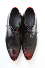 Elegant pair of black and burgundy leather dress shoes on a white background.