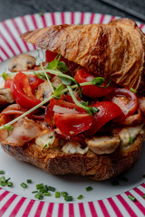 Croissant with filling on a beautiful plate isolated