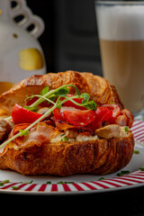 Croissant with filling on a beautiful plate isolated