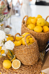 Rustic summer decor with fresh lemons and woven baskets
