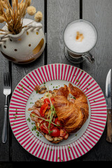 Croissant with filling on a beautiful plate isolated