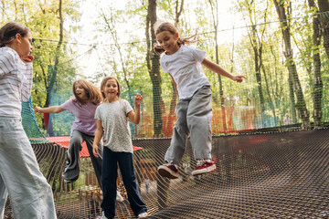 Weekend activities, fun. Kids are playing on the children's amusement ropes course