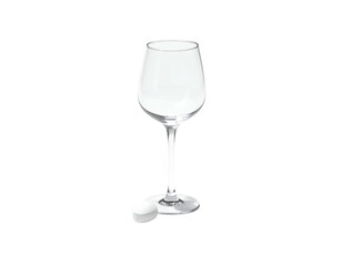 A clear, stemmed wine glass stands with a white stopper against a black background