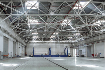 Vast, modern industrial facility. Showcase manufacturing, engineering, and logistics concepts with this wide-angle shot of a clean, well-lit factory floor and production hall. Ideal for business and