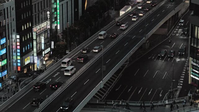 Night in Tokyo : Rush Hour. Line of Cars on the Elevated Metropolitan Expressway Running Parallel to the Public Road. Beneath It Is a Pedestrian Bridge  |  Shuto Expressway, Shibuya, Tokyo, Japan
