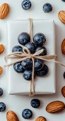 Gift wrapped in white, decorated with blueberries & almonds