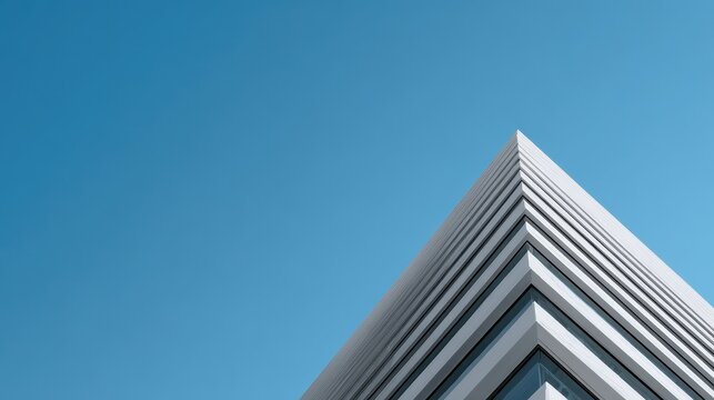 Sharp Corner of a Modern Minimalist Building Against Blue Sky