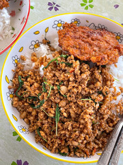  Rice topped with stir fried minced pork and basil. Stir fried curry paste in Thailand.
