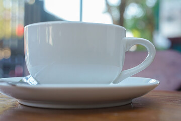 A cup of coffee with latte art on a wooden table
