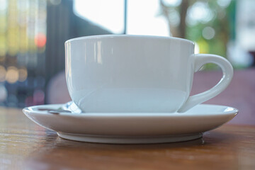 A cup of coffee with latte art on a wooden table