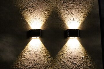 A lamp for illuminating a room at night. An incandescent lamp is an artificial light source.