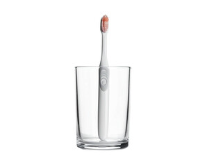 A white toothbrush with a red bristle head stands in a clear glass