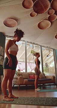 Two women gracefully perform various yoga poses, emphasizing health, wellness, and mindfulness.