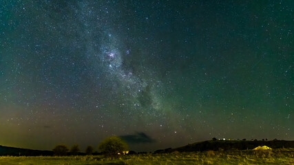 The Milky Way Night Sky with a hint of the Aurora over the countryside
