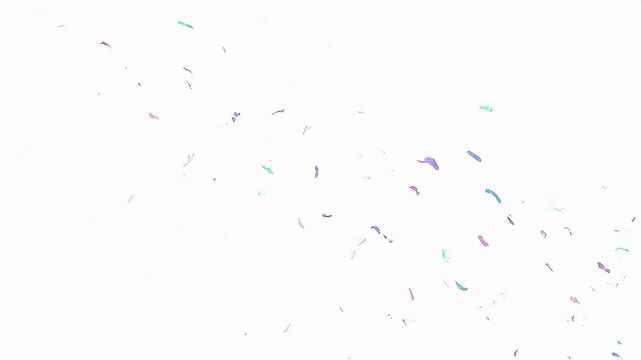 Abstract Colorful Confetti-Like Particles Gently Floating and Dispersing on a Pristine White