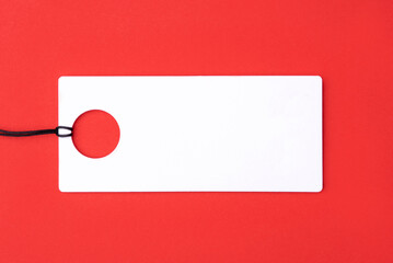 Empty white tag on red background.