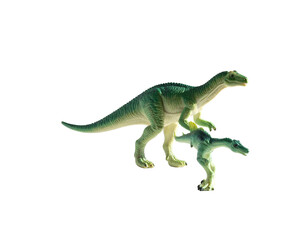 Obraz premium Two plastic toy dinosaurs, one atop the other, against a stark black background