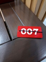 Lucky Number 007 Tag on Wooden Surface
