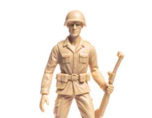 Tan plastic toy soldier stands at attention, holding a rifle, isolated on black