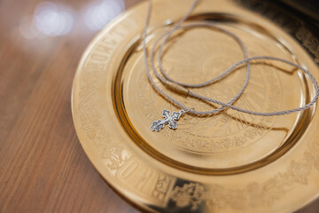 Silver Cross Necklace on Ornate Golden Plate