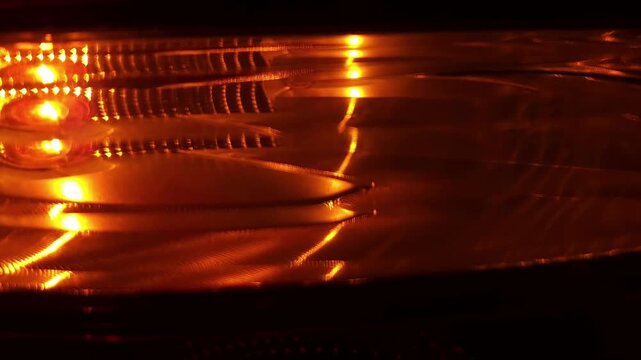 Slow motion Close up of a car's blinker indicating the direction change at night