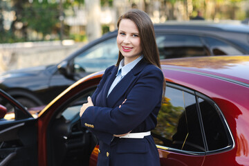 Attractive young female driver in casual outfit, driving car, road safety and transportation theme.Young woman driving car. Travel concept.

