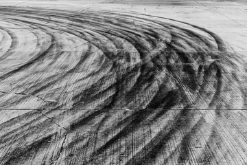 Black tire marks on road, Black rubber tire marks and tread marks, Tire trace track wheels texture and background, Auto tire tread grunge, Car wheel tyre tread track black tyre print. © Kalyakan
