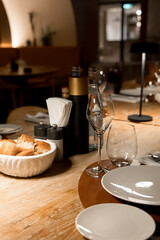 Cozy Fine Dining Table Setting with Fresh Bread and Wine Glasses  