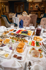 Top view of table with meat, salads, and desserts.