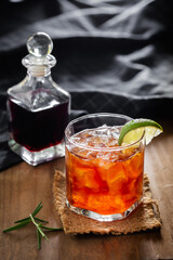 Refreshing Cocktail with Lime Garnish on a Wooden Table