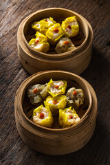 Delicious dim sum in bamboo steamers with succulent fillings