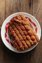 Crispy Pork Belly Served on Decorated Plate with Rustic Wooden Background