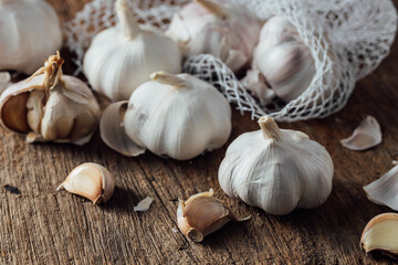Fresh Garlic Bulbs and Cloves on Rustic Wooden Table Surface