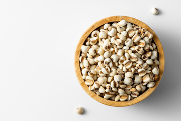 Healthy Organic Popcorn Kernels in Wooden Bowl on White Background