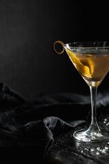 Elegant Cocktail with Lemon Twist in Dark Setting at Bar
