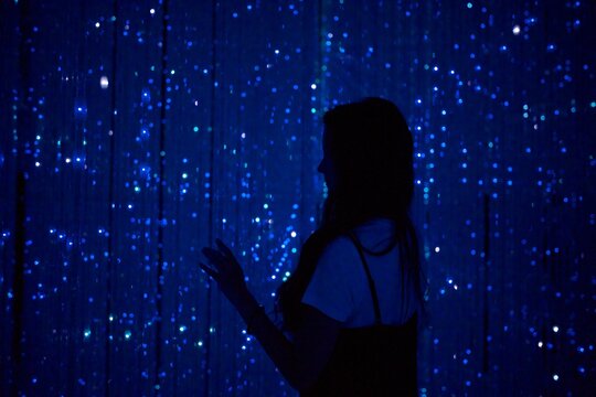 Woman in glowing blue futuristic light art Tokyo