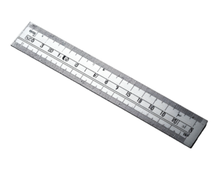 A clear plastic measuring tool with etched markings on a dark background