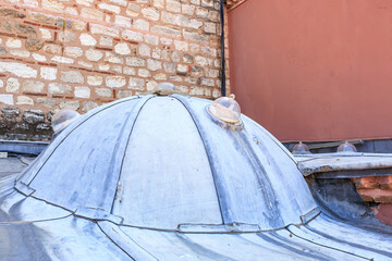 Historic ottoman hamam dome with unique architecture and skylights on stone wall in istanbul