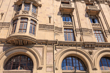 Architectural detail of historic stone building with arched windows and ornate design