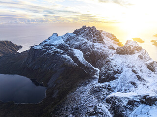 Lake amid snowcapped mountains in autumn mist, Nusfjord, Lofoten Islands, Norway
