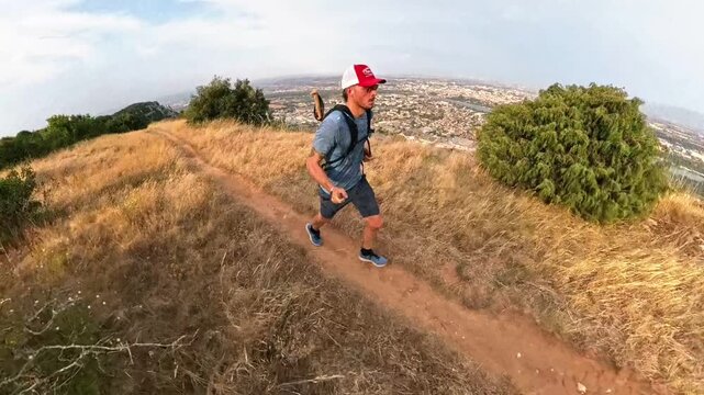 Trail Man Run Holding a 360 Camera Along a Cliff Overlooking the Rhone Valley