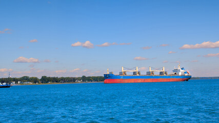 Fototapeta premium Large ship anchored in the middle of the great St. Lawrence River in Canada