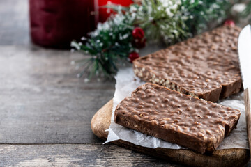 Chocolate nougat bar with puffed rice on wooden table