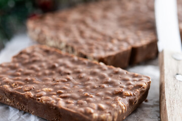 Chocolate nougat bar with puffed rice on wooden table